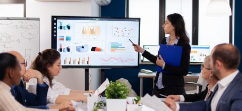 Young team leader in big corporation briefing coworkers